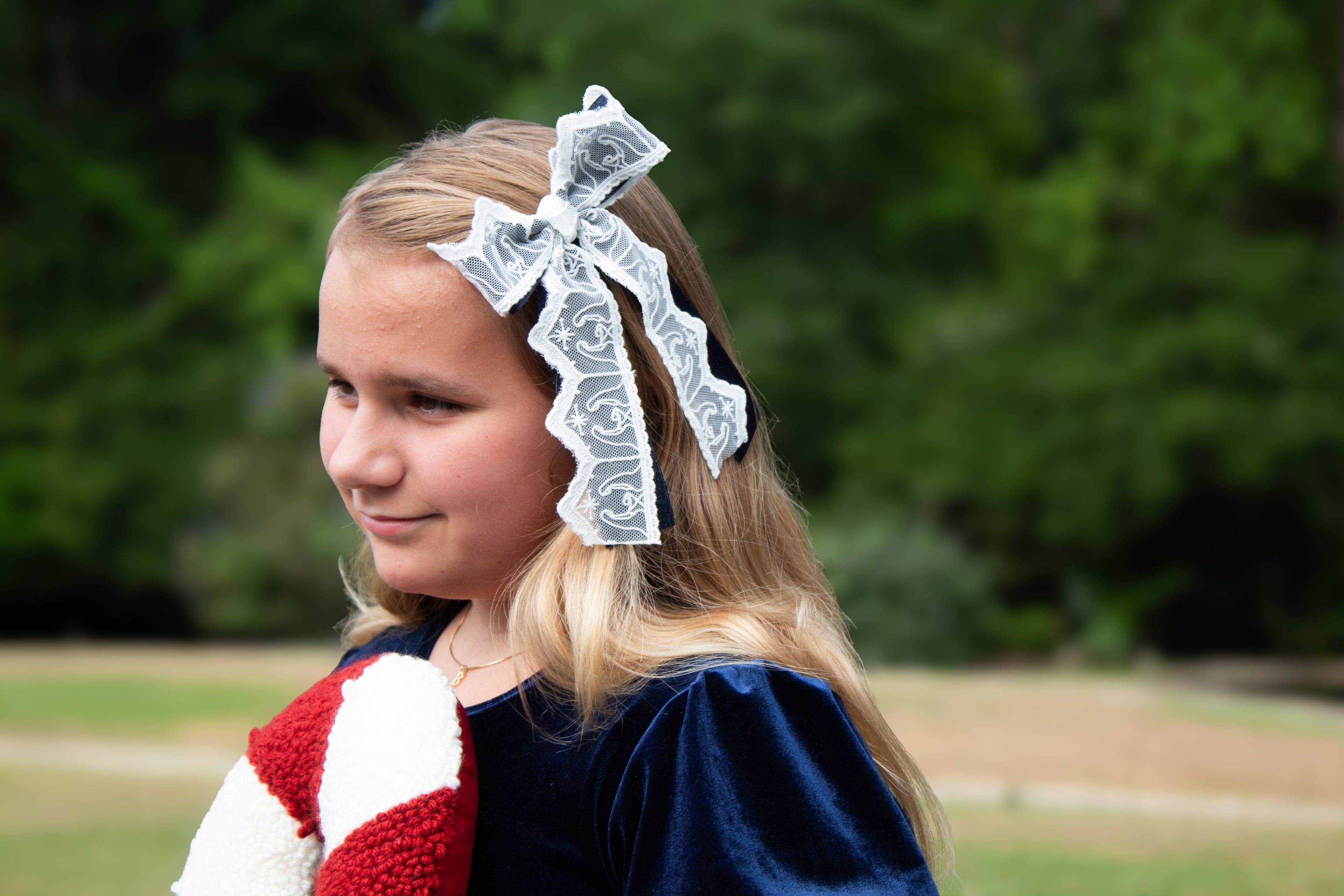 Nativity Lace layered with stardust dark navy satin bow