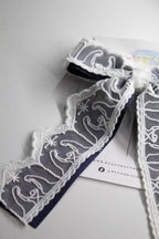 Nativity Lace layered with stardust dark navy satin bow