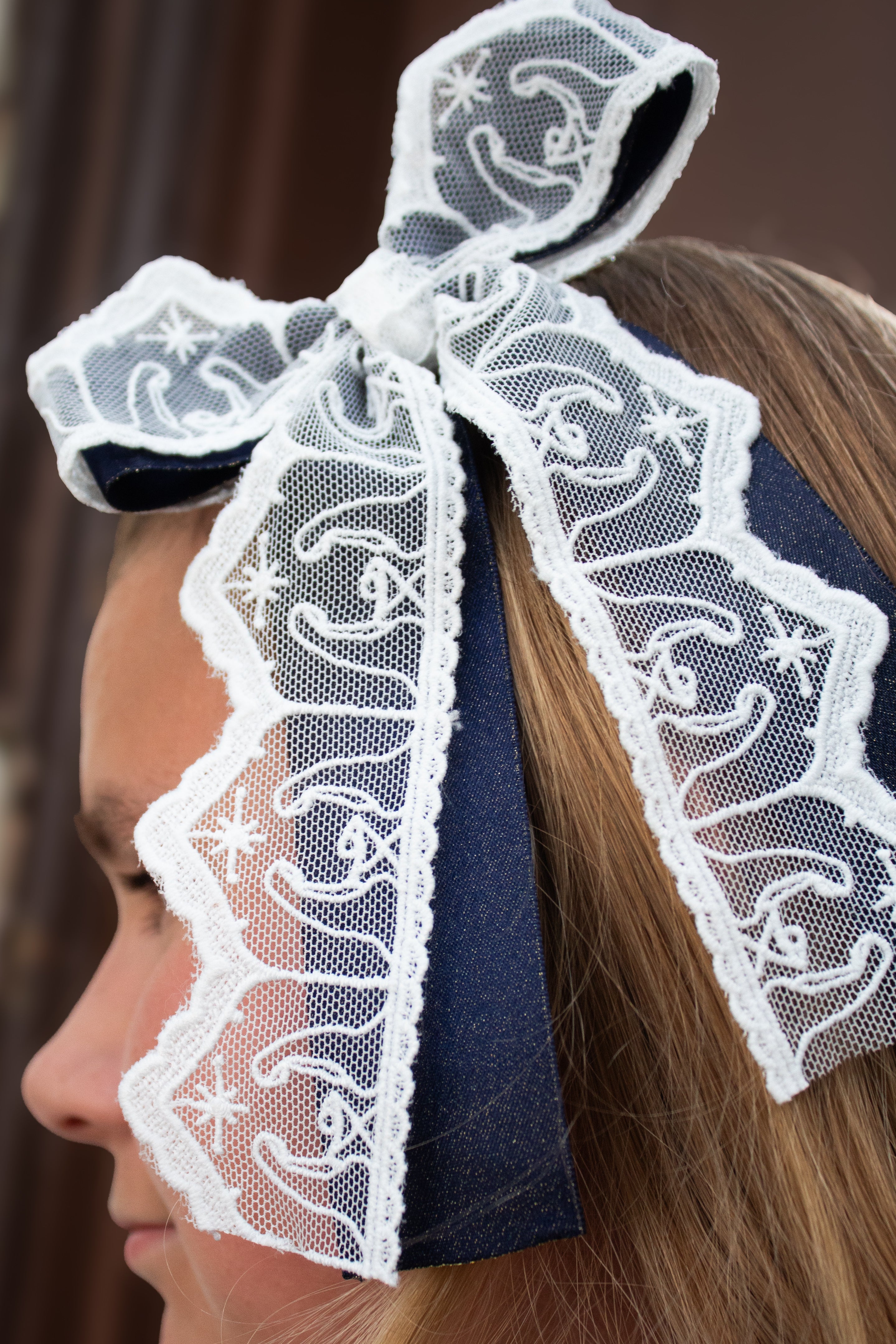 Nativity Lace layered with stardust dark navy satin bow
